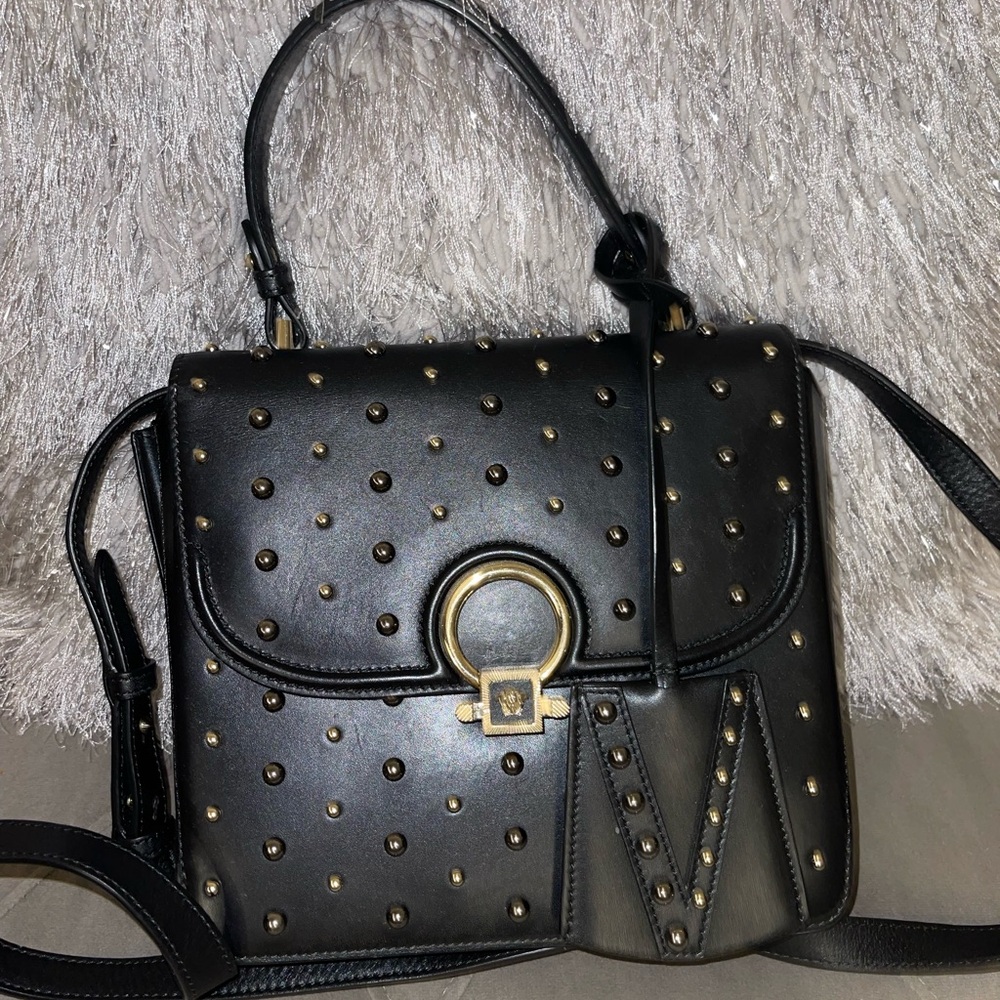 This a black genuine, leather Versace bag.